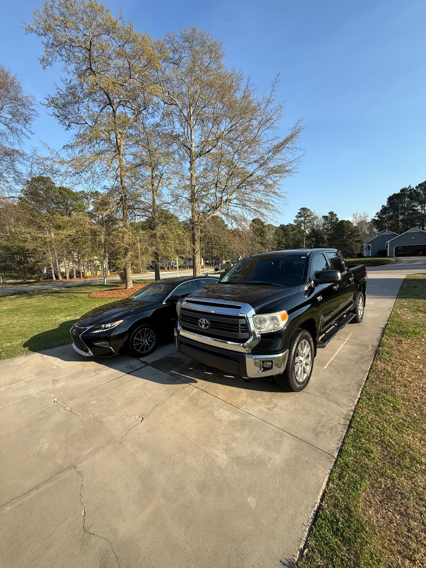 Black truck and sedan after detail