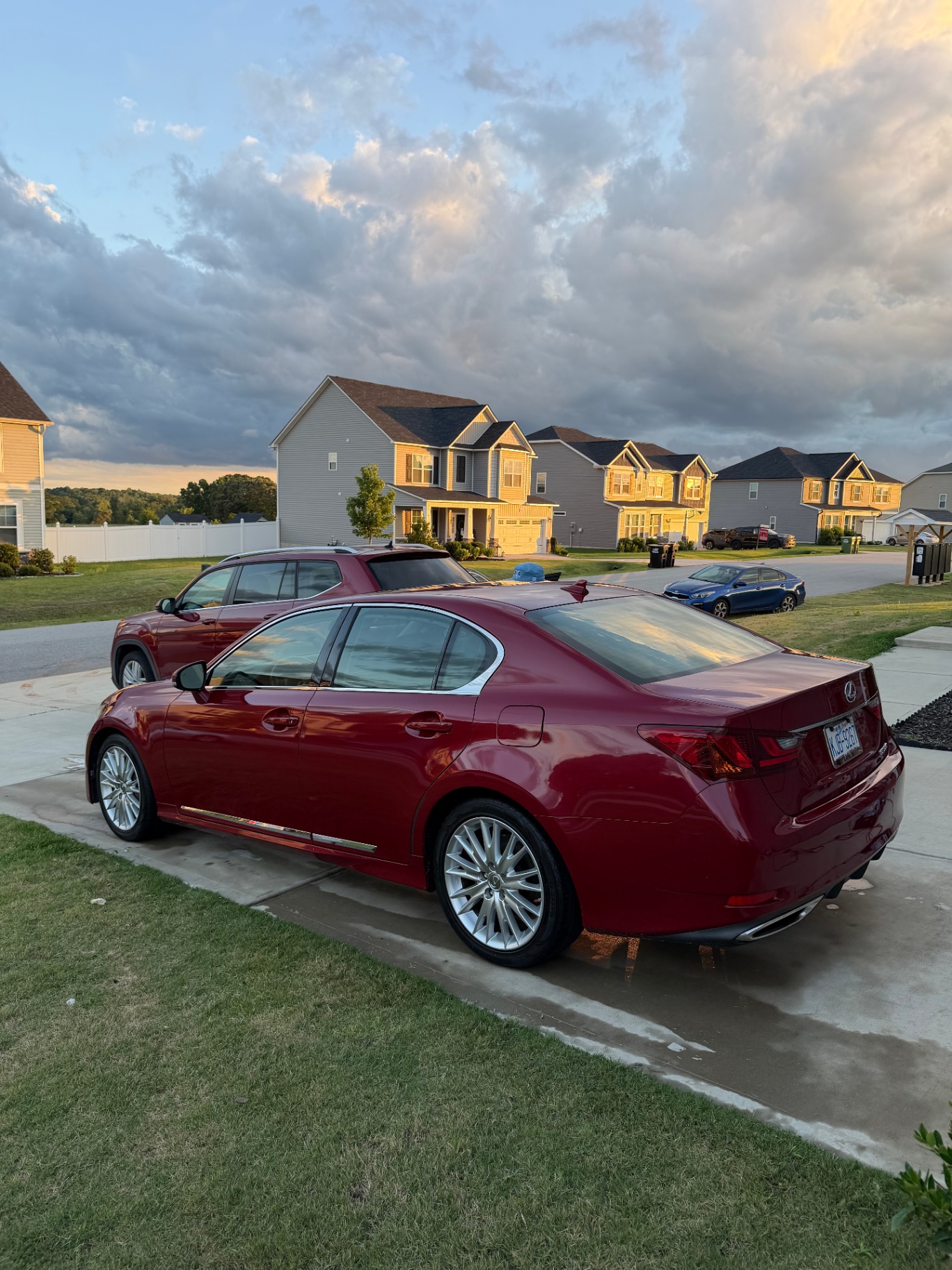 Red Lexus sedan at sunset